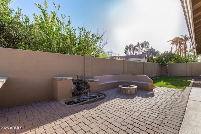 view of patio / terrace featuring a fire pit and a fenced backyard