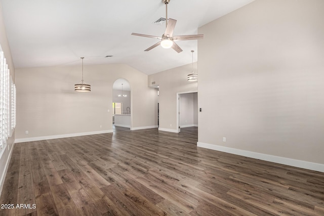 unfurnished living room featuring dark wood-style floors, visible vents, a ceiling fan, and vaulted ceiling