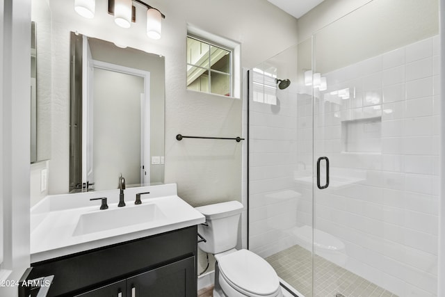 full bathroom with a shower stall, toilet, and vanity