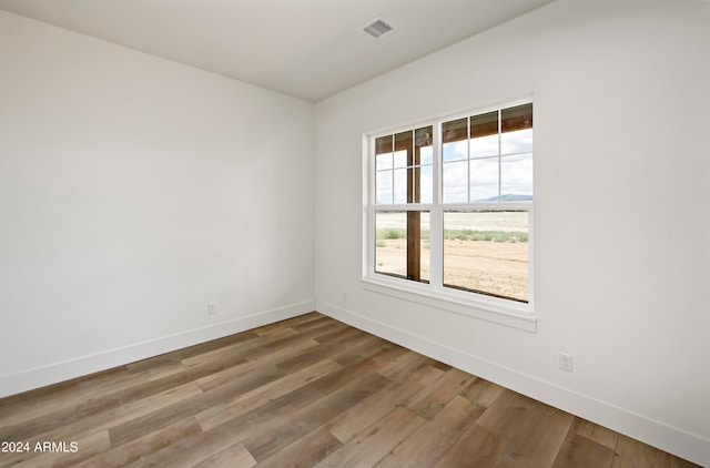 unfurnished room with hardwood / wood-style floors