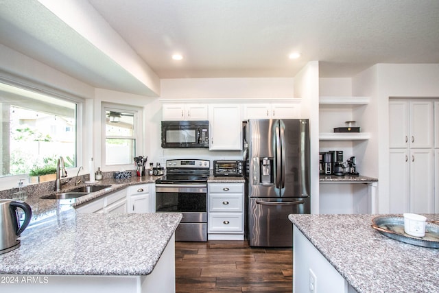 kitchen featuring white cabinets, stainless steel appliances, sink, and dark hardwood / wood-style floors