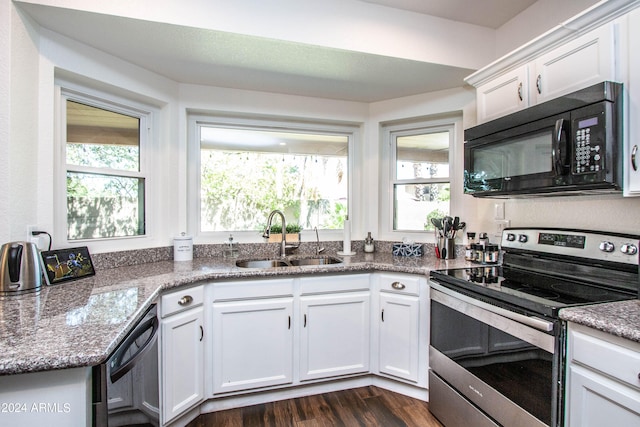 kitchen with electric stove, sink, white cabinetry, and dishwashing machine