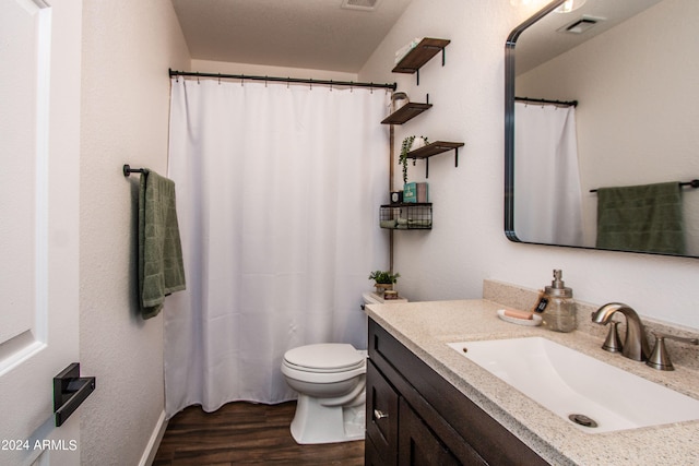 bathroom with a shower with curtain, wood-type flooring, toilet, and vanity