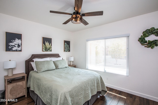 bedroom with dark wood-type flooring and ceiling fan