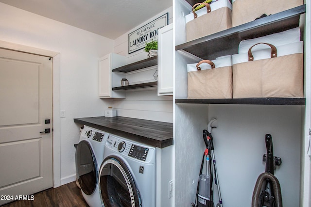 laundry area with dark wood-type flooring, cabinets, and washer and dryer