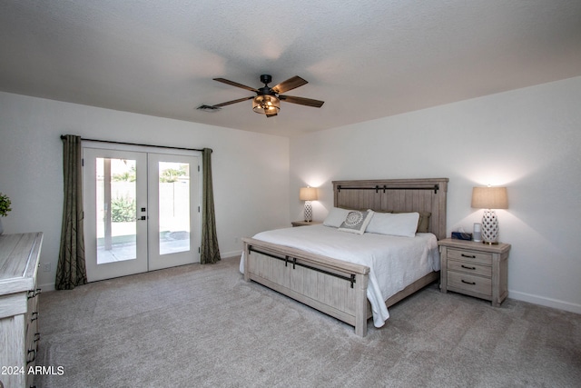 carpeted bedroom with a textured ceiling, access to exterior, ceiling fan, and french doors