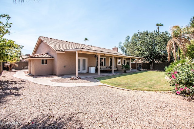 back of house with a yard, ceiling fan, and a patio