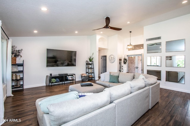 living room with a textured ceiling, dark hardwood / wood-style flooring, ceiling fan, and vaulted ceiling