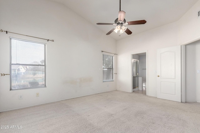 unfurnished bedroom featuring a ceiling fan, visible vents, high vaulted ceiling, carpet flooring, and connected bathroom