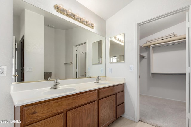 bathroom with tile patterned flooring, double vanity, baseboards, and a sink