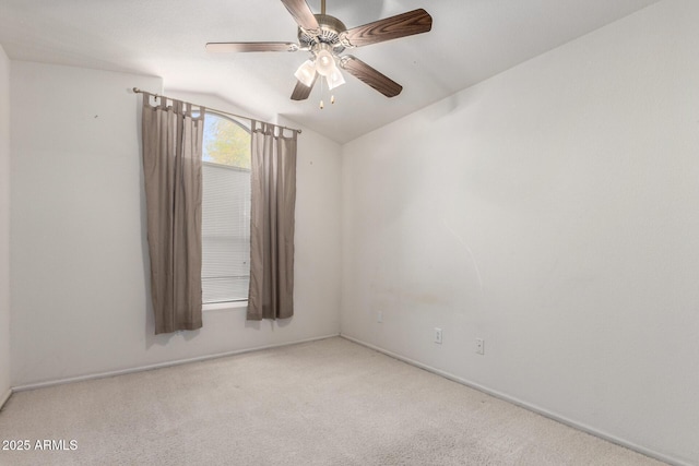 carpeted spare room with lofted ceiling and a ceiling fan