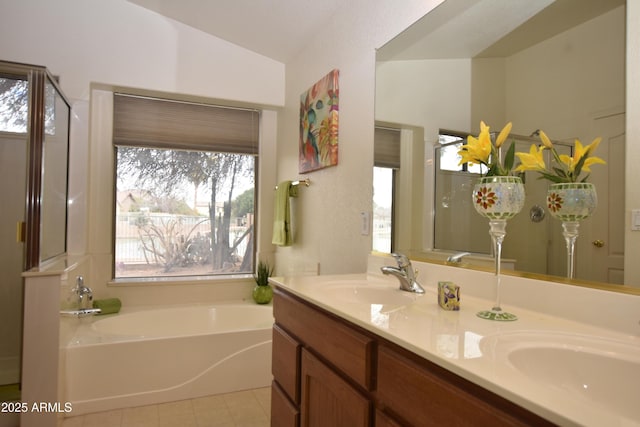 full bathroom featuring double vanity, a bath, vaulted ceiling, and a sink