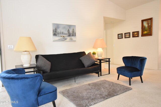 carpeted living area with lofted ceiling