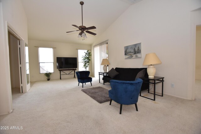 living area with plenty of natural light, carpet flooring, and high vaulted ceiling