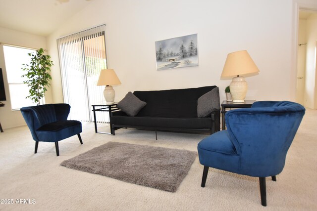 living area with plenty of natural light, carpet floors, and vaulted ceiling