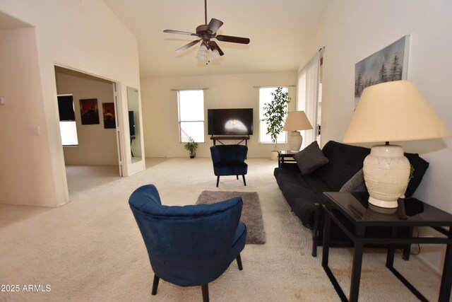 carpeted living room with high vaulted ceiling and ceiling fan