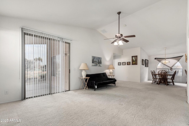 living area featuring a wealth of natural light, lofted ceiling, carpet, and ceiling fan