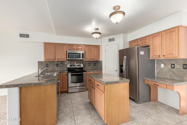 kitchen featuring a peninsula, visible vents, appliances with stainless steel finishes, light tile patterned flooring, and a sink