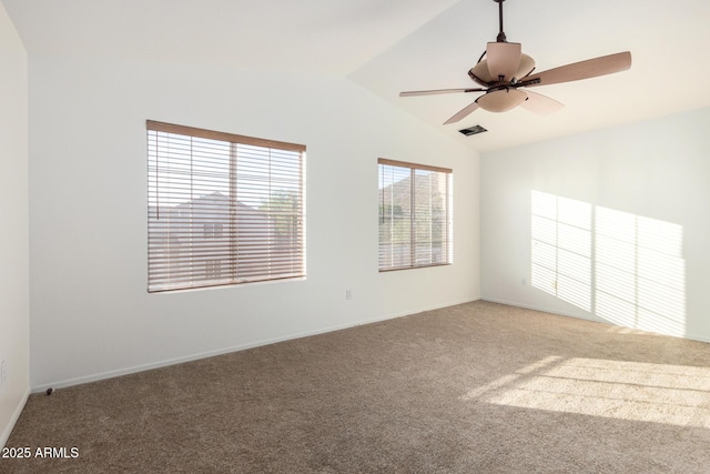 spare room with visible vents, a ceiling fan, light colored carpet, and vaulted ceiling
