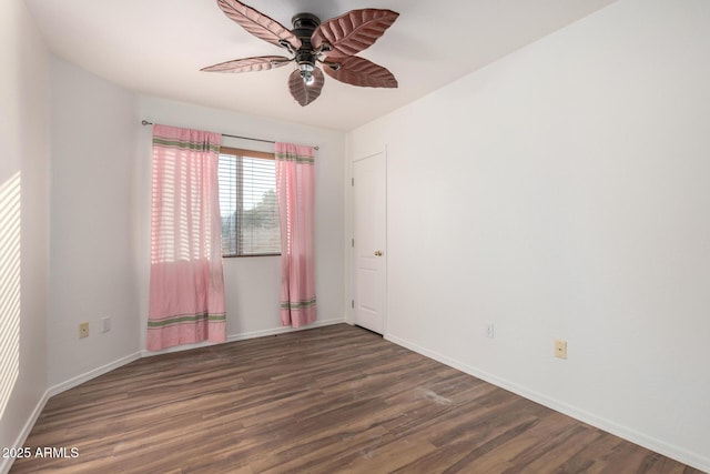 unfurnished room featuring wood finished floors, baseboards, and a ceiling fan