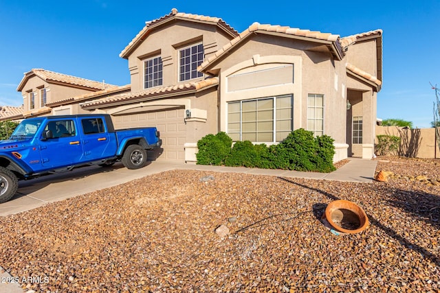 view of front facade featuring a tiled roof, a garage, stucco siding, and concrete driveway