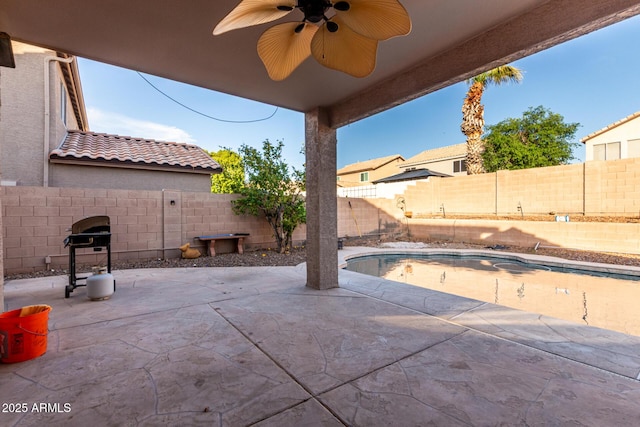 view of patio / terrace featuring grilling area, a fenced backyard, a fenced in pool, and a ceiling fan