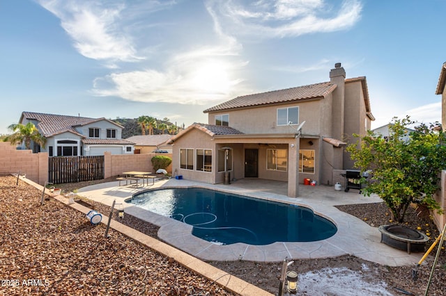 view of swimming pool with an outdoor fire pit, a patio, a fenced backyard, and a fenced in pool