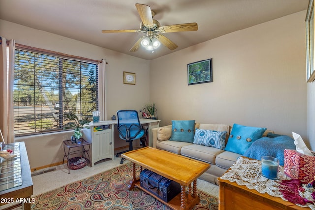 living room featuring light colored carpet and ceiling fan