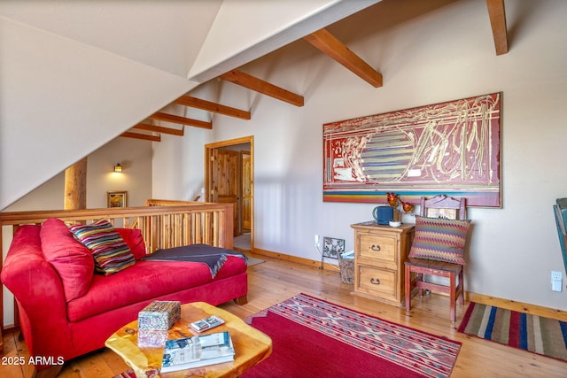 living room featuring lofted ceiling with beams and wood-type flooring