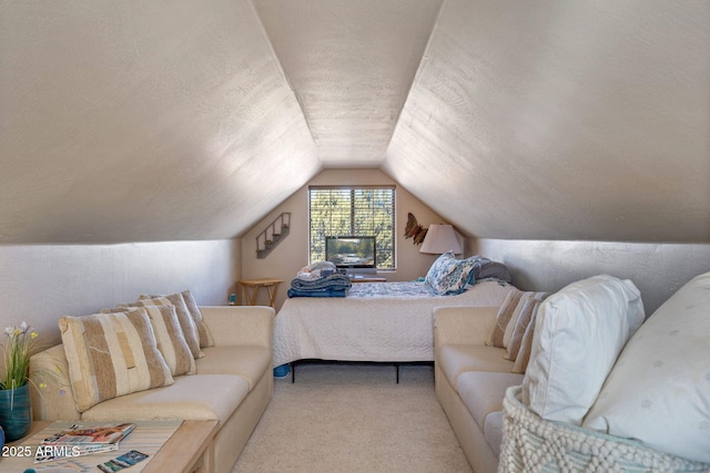 bedroom with light carpet, vaulted ceiling, and a textured ceiling