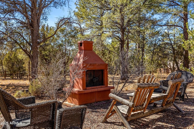 view of yard with an outdoor fireplace