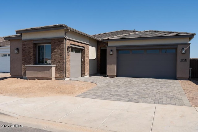 1254 E Penedes Dr, Gilbert, AZ 85298 - prairie-style home with stucco siding, decorative driveway, a garage, and a tile roof