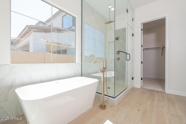1254 E Penedes Dr, Gilbert, AZ 85298 - bathroom with a shower stall, wood finished floors, a soaking tub, and a walk in closet