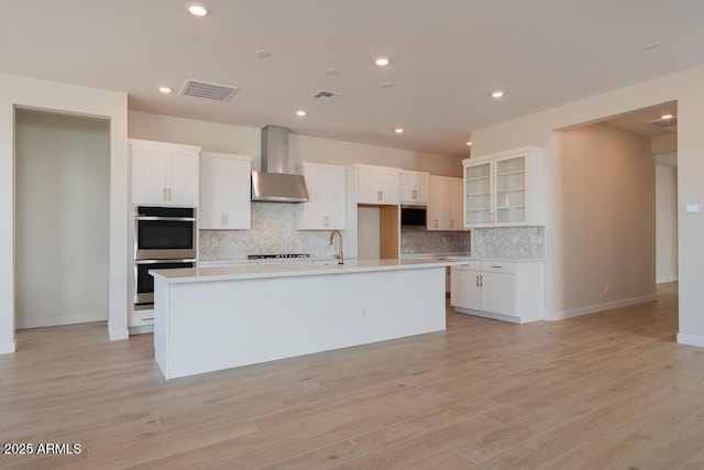 1254 E Penedes Dr, Gilbert, AZ 85298 - kitchen with wall chimney exhaust hood, stainless steel appliances, tasteful backsplash, a kitchen island with sink, and recessed lighting