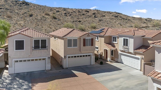421 W Mountain Sage Dr, Phoenix, AZ 85045 - mediterranean / spanish home featuring an attached garage, driveway, and a mountain view