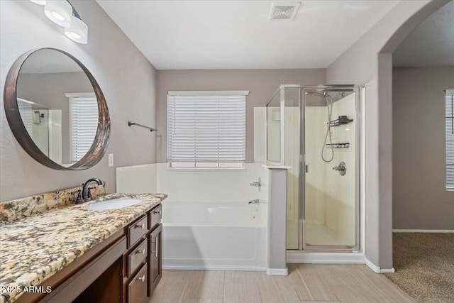 421 W Mountain Sage Dr, Phoenix, AZ 85045 - full bath featuring a garden tub, a stall shower, vanity, and baseboards
