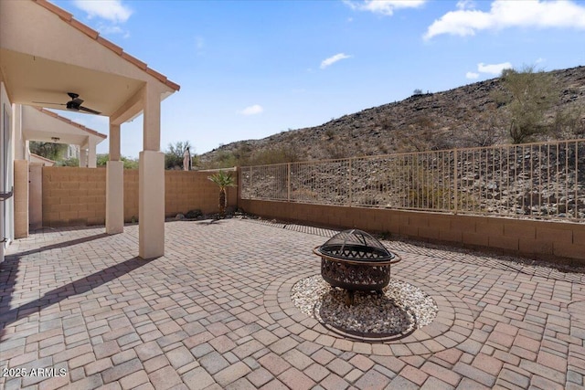421 W Mountain Sage Dr, Phoenix, AZ 85045 - fenced backyard featuring ceiling fan, a fire pit, a patio, and a mountain view