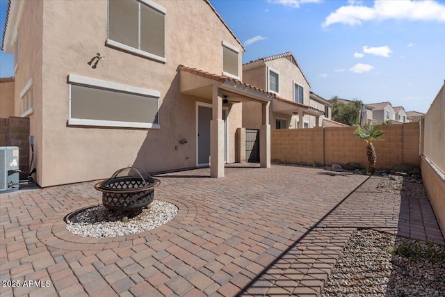 421 W Mountain Sage Dr, Phoenix, AZ 85045 - back of house with stucco siding, a fire pit, a fenced backyard, and a patio area