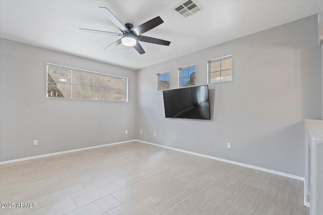 421 W Mountain Sage Dr, Phoenix, AZ 85045 - empty room with ceiling fan, healthy amount of natural light, and baseboards