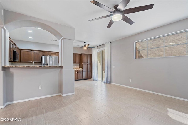 421 W Mountain Sage Dr, Phoenix, AZ 85045 - unfurnished living room featuring a ceiling fan, arched walkways, ornate columns, baseboards, and recessed lighting