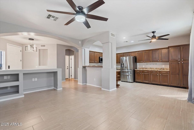 421 W Mountain Sage Dr, Phoenix, AZ 85045 - unfurnished living room featuring a ceiling fan, arched walkways, baseboards, recessed lighting, and light wood-type flooring