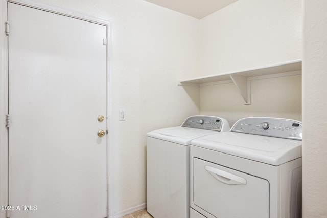 laundry area featuring laundry area, baseboards, and independent washer and dryer