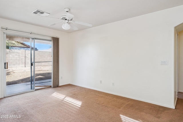 empty room featuring baseboards, carpet, visible vents, and a ceiling fan