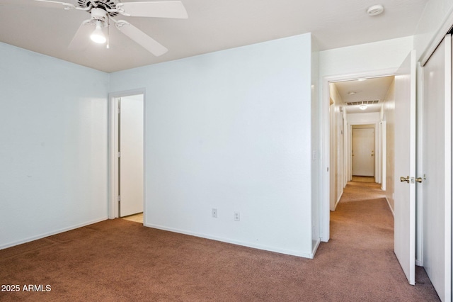 unfurnished bedroom featuring a closet, light colored carpet, and baseboards