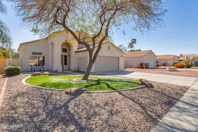 mediterranean / spanish-style house featuring driveway, a tiled roof, an attached garage, fence, and stucco siding