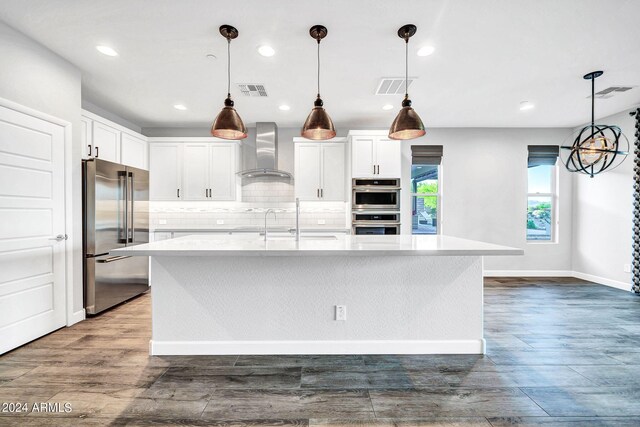 kitchen with visible vents, stainless steel dishwasher, dark wood-type flooring, white cabinets, and a sink