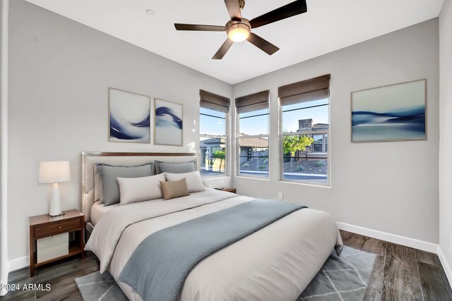 spare room with ceiling fan, wood finished floors, visible vents, and baseboards