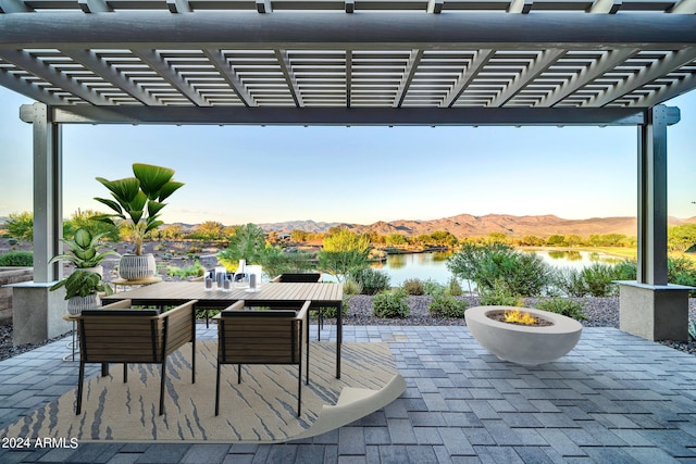 view of patio featuring a pergola and a water and mountain view