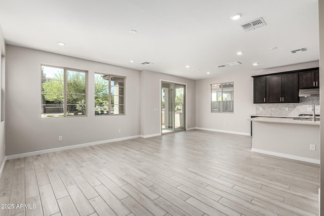 9366 E Sequence Ave, Mesa, AZ 85212 - unfurnished living room with light wood-style flooring and recessed lighting