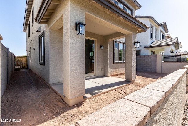 9366 E Sequence Ave, Mesa, AZ 85212 - view of exterior entry featuring stucco siding, a patio area, and a gate